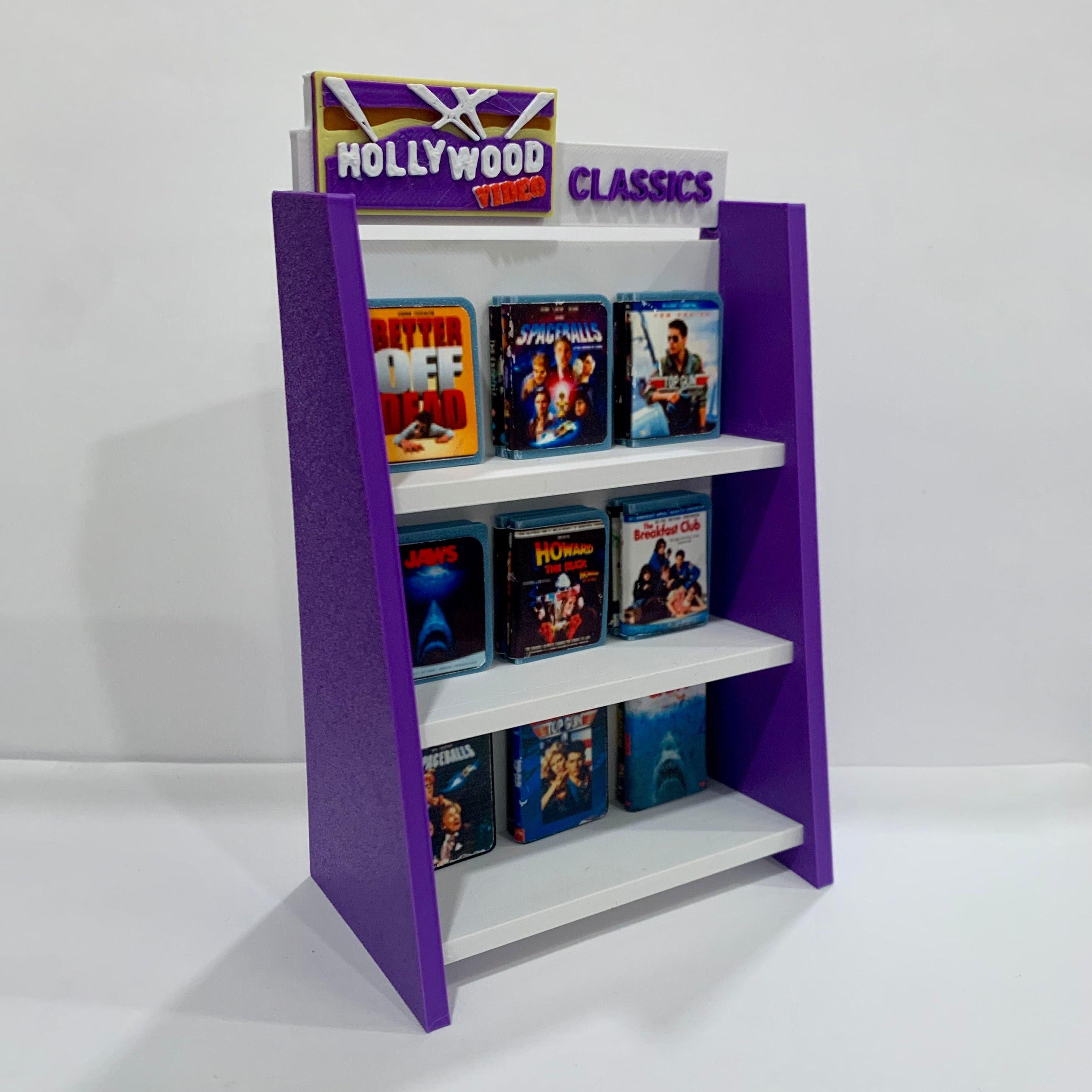 Purple and white display rack with DVD cases on a white background
